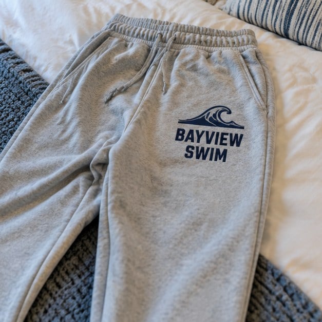 Customer photo of custom sweatpants on a bed